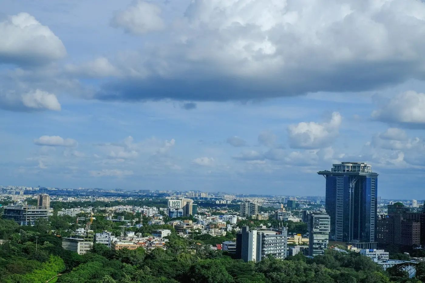 The Bangalore skyline over green neighbourhoods on a clear day