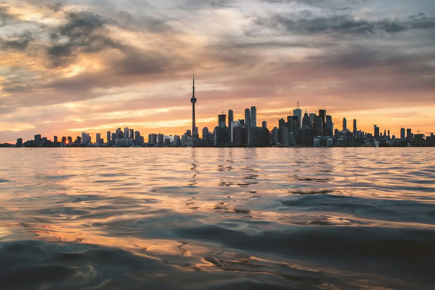 The Toronto skyline and CN Tower across Lake Ontario at golden hour