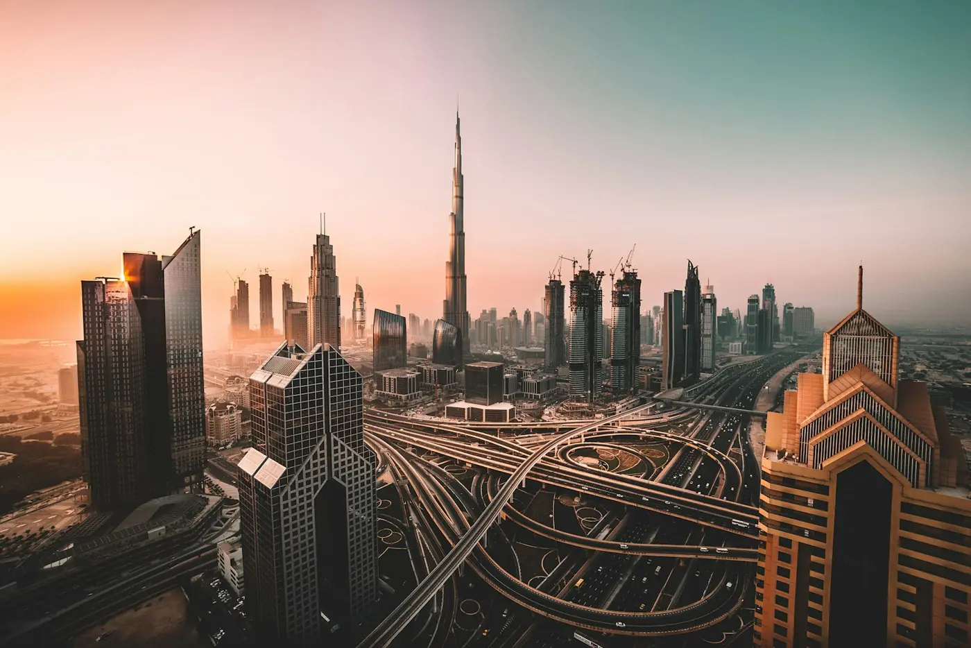 The Burj Khalifa and Dubai skyline above a highway interchange