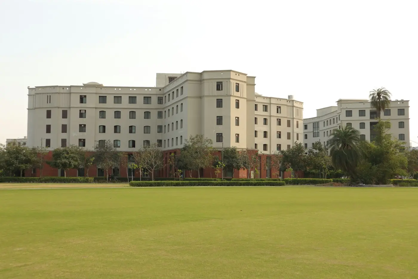 A college campus building across a green lawn
