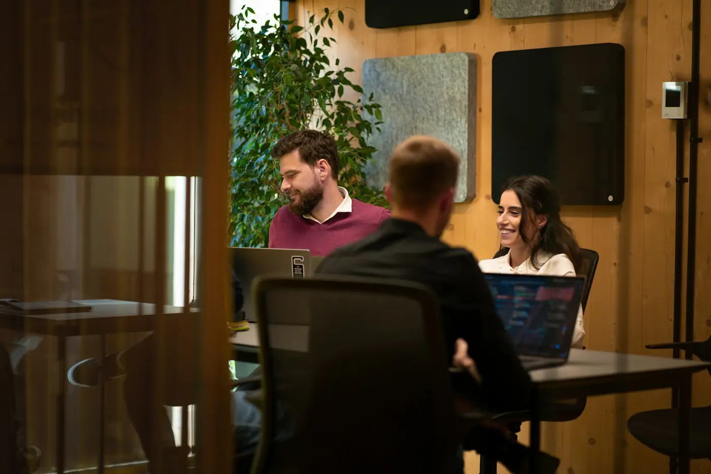 A startup team working together on laptops in an office